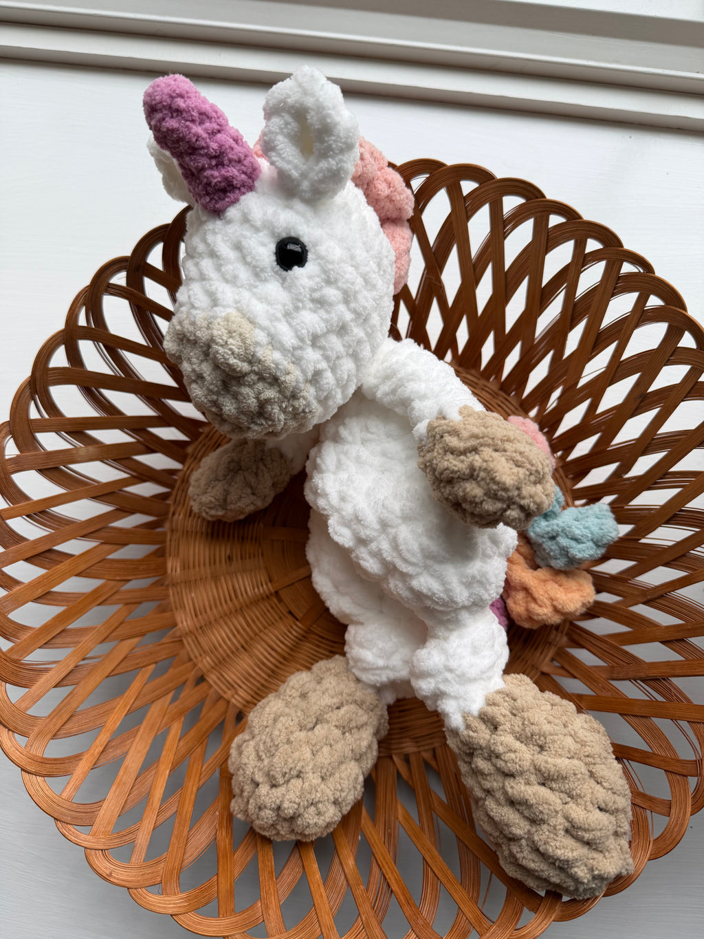 Handmade crochet unicorn snuggler